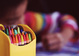 The author, hard at work. (Image shows a child writing with crayons)